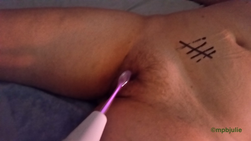 I am lying on my back while He applies what looks like a toothbrush to my bush. But it is a violet wand and this is electric play.