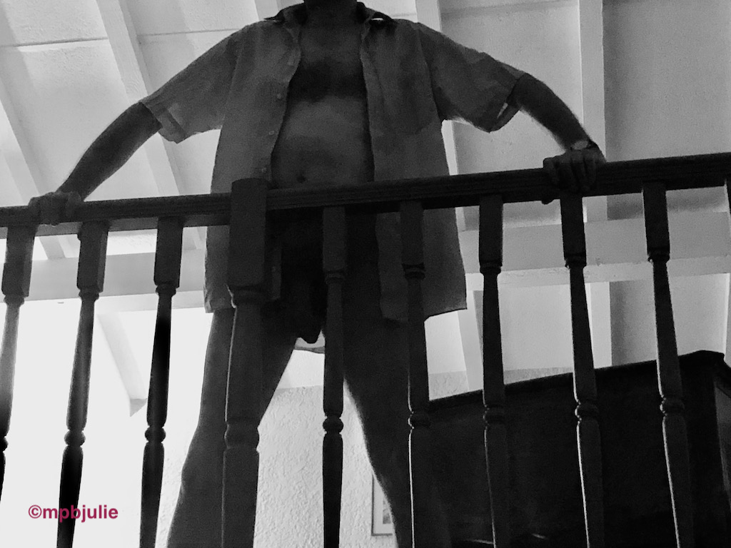 Master standing at the railings of the mezzanine floor of an apartment we stayed in this summer. 
