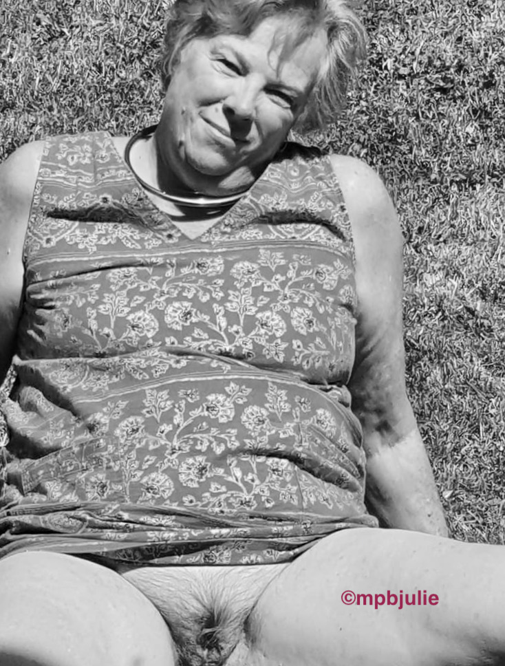 I'm relaxing on the grass in a summer dress which is pulled up so you can see my bare cunt. 