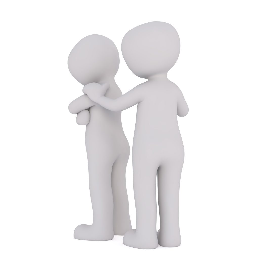 2 figures one behind the other. The front one has their arms crossed. The behind on has their hand on the other's shoulder. 