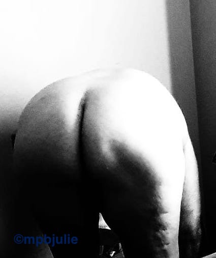A black and white photo of my bottom. I'm bending over while naked.