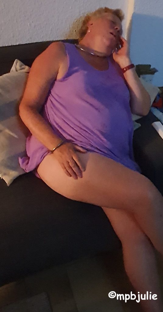 Me sitting on the sofa at my holiday apartment in France. I'm wearing a purple dress pulled up under my bottom, so showing my half tanned leg. I'm asleep!