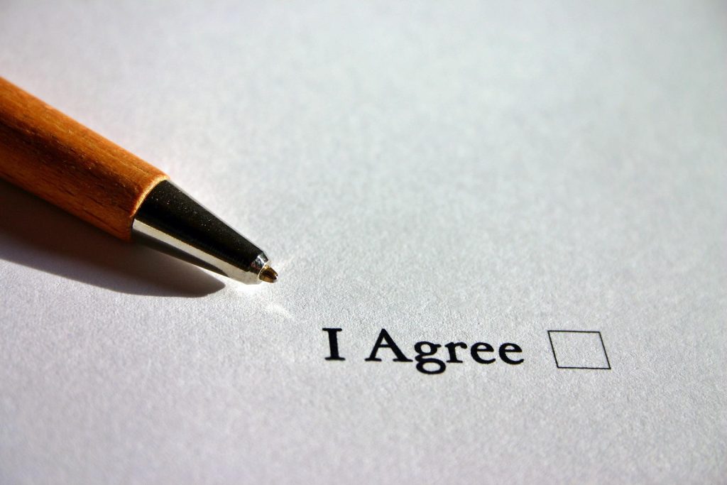 Contract - a pen and the words I agree and a box