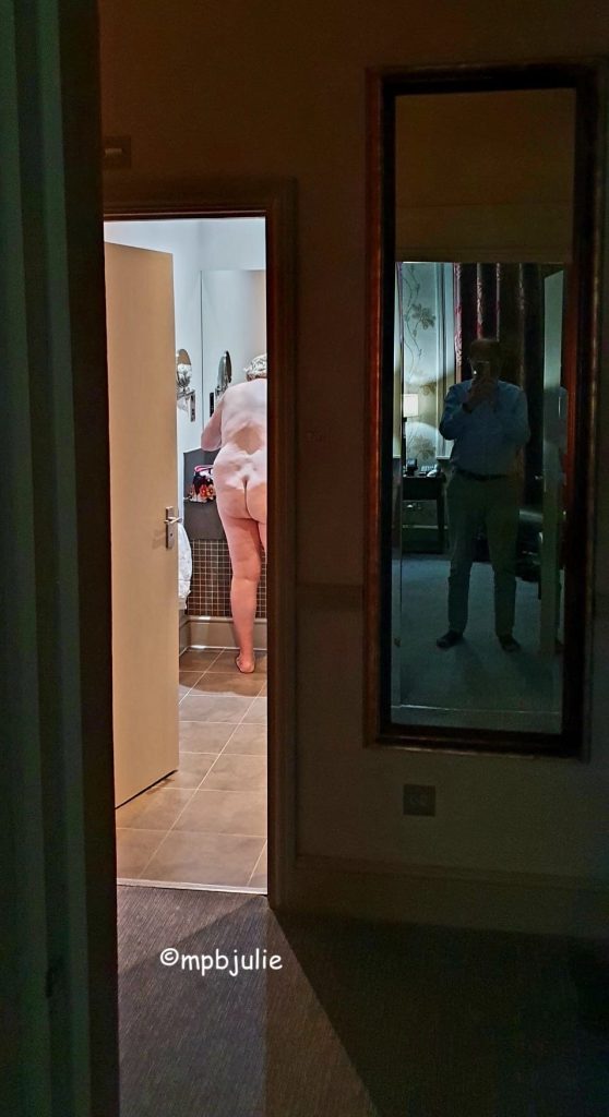 I'm in the bathroom naked. Back to the door at the sink, cleaning my teeth. Apparently next to me, in a mirror master fully clothed he is taking a photo. A mirror image.