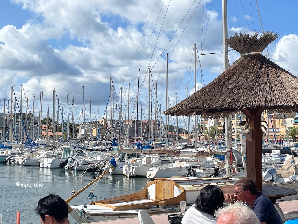 Harbour area. Sailing boats agains a blue sky with clouds