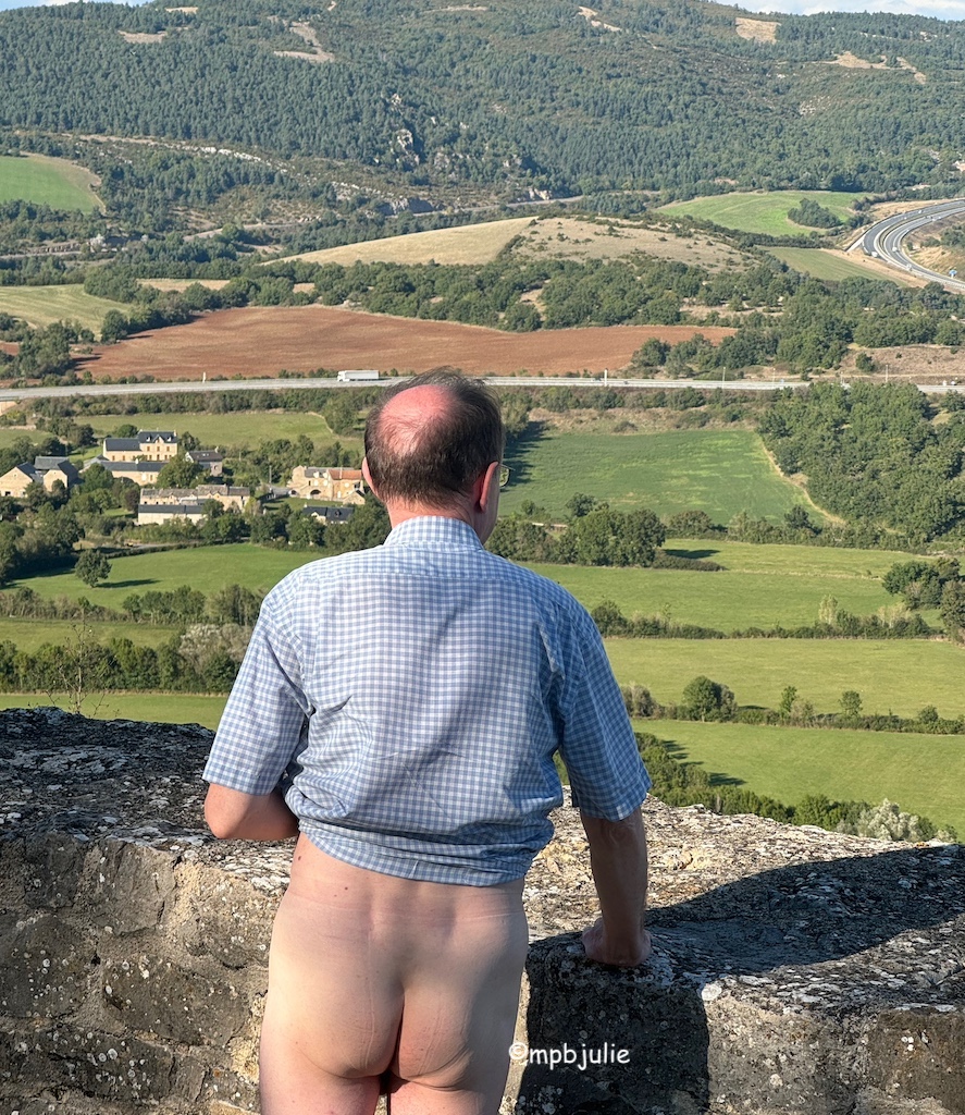 An amazing French rural view of fields, hills., houses and a man with a checked shirt and a really great arrse!